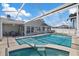 Relaxing, screened-in pool and patio area with a view of the canal and boat dock, perfect for enjoying sunny days at 5000 Galleon Ct, New Port Richey, FL 34652