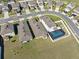 A birdseye view of homes displays well-kept yards and a fenced pool area, giving insight into outdoor living spaces at 5388 Fez Ct, Brooksville, FL 34602