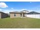 Expansive backyard with a covered patio, and white vinyl fence, ideal for outdoor enjoyment at 5388 Fez Ct, Brooksville, FL 34602