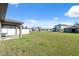 Large, grassy backyard with a patio area and a white fence, offering plenty of space at 5388 Fez Ct, Brooksville, FL 34602