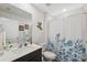 Bright bathroom featuring a large mirror, white countertop, and floral shower curtain at 5388 Fez Ct, Brooksville, FL 34602