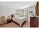 Bright bedroom featuring natural light, a wooden bed frame, and carpeted floors at 5388 Fez Ct, Brooksville, FL 34602