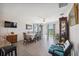 Spacious dining room featuring wood floors, a large table, and natural light from sliding glass doors at 5388 Fez Ct, Brooksville, FL 34602