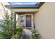 Inviting front porch with decorative plants and a wreath on the front door at 5388 Fez Ct, Brooksville, FL 34602