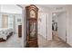Hallway with a grandfather clock separating the primary bedroom and the hallway bathroom and closet at 5388 Fez Ct, Brooksville, FL 34602