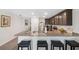 Open kitchen with granite countertops, stainless appliances, and breakfast bar seating at 5388 Fez Ct, Brooksville, FL 34602