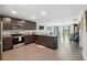 Stylish kitchen with dark cabinets, stainless steel appliances, and an island at 5388 Fez Ct, Brooksville, FL 34602