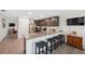 Open kitchen with granite countertops, stainless appliances, and breakfast bar seating at 5388 Fez Ct, Brooksville, FL 34602