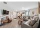 Comfortable living room with a gray leather sofa and modern flooring at 5388 Fez Ct, Brooksville, FL 34602
