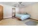 A cozy bedroom with a ceiling fan, carpet flooring, and a large window with ample natural light at 5441 Alderwood St, Spring Hill, FL 34606