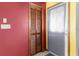 A view of the hallway featuring wood-slatted closet and a bright yellow wall at 5441 Alderwood St, Spring Hill, FL 34606