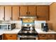 Kitchen featuring stainless steel range, microwave and coffee maker; upper cabinets at 5441 Alderwood St, Spring Hill, FL 34606