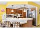 Kitchen with eat-in bar, stainless steel refrigerator, and pendant lighting at 5441 Alderwood St, Spring Hill, FL 34606
