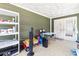 Enclosed patio area with tile flooring, storage shelves, and convenient access to the outdoors through double doors at 5441 Alderwood St, Spring Hill, FL 34606
