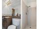 Cozy bathroom featuring a wooden sink vanity, white shower and a mosaic-style floor at 6259 Hillview Rd, Spring Hill, FL 34606