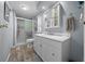 Bathroom showcasing a vanity with drawers, a toilet, and a shower with a glass door at 6448 W Richard Dr, Weeki Wachee, FL 34607