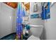 Bright bathroom features a shower, toilet, and sink with fish-themed decorations at 6448 W Richard Dr, Weeki Wachee, FL 34607
