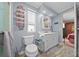 Well-lit bathroom featuring a white vanity, toilet, window and towel rack at 6448 W Richard Dr, Weeki Wachee, FL 34607