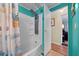 Bathroom showing a shower-tub combo with shower head, and doorway leading to a bedroom at 6448 W Richard Dr, Weeki Wachee, FL 34607