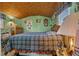This bedroom features a large window, wood furniture, and bamboo ceiling at 6448 W Richard Dr, Weeki Wachee, FL 34607