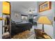Bedroom with a black bed, floral rug, black furniture, and two windows with shades at 6448 W Richard Dr, Weeki Wachee, FL 34607