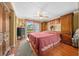 Spacious bedroom with a large bed, wood cabinets, and a sliding glass door to a balcony at 6448 W Richard Dr, Weeki Wachee, FL 34607