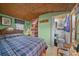 Comfortable bedroom featuring ensuite bath and charming bamboo ceiling with stylish decor at 6448 W Richard Dr, Weeki Wachee, FL 34607