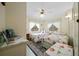 Bright bedroom featuring two beds with floral spreads, white walls, and a ceiling fan at 6448 W Richard Dr, Weeki Wachee, FL 34607