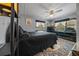 Well-lit bedroom with a large bed, dresser, ceiling fan, and decorative accents at 6448 W Richard Dr, Weeki Wachee, FL 34607