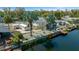 Exterior view of home on canal with dock, landscaping, and boat storage at 6448 W Richard Dr, Weeki Wachee, FL 34607