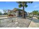 Welcoming home exterior with a charming swing, lush landscaping, and scenic surroundings at 6448 W Richard Dr, Weeki Wachee, FL 34607