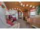 Relaxing living room featuring charming bamboo ceiling, comfortable furnishings and a functional kitchenette area at 6448 W Richard Dr, Weeki Wachee, FL 34607