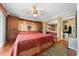 Bright main bedroom featuring a ceiling fan, and a large built-in cabinet and a closet at 6448 W Richard Dr, Weeki Wachee, FL 34607