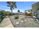The canal-front home features an outdoor swing, an American flag, and meticulously landscaped yard at 6448 W Richard Dr, Weeki Wachee, FL 34607
