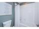Bathroom with white subway tiles, a tub, and a framed 'I love you' print at 6482 Beverly Hills Dr, Zephyrhills, FL 33541