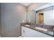 Bathroom featuring a double sink vanity with granite countertop and white cabinets at 6482 Beverly Hills Dr, Zephyrhills, FL 33541