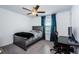 Bedroom with a gray bed frame, sleek black desk, and large window at 6482 Beverly Hills Dr, Zephyrhills, FL 33541