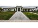 Community clubhouse showcasing a brick walkway and landscaped grounds at 6482 Beverly Hills Dr, Zephyrhills, FL 33541