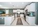 Bright kitchen boasts white cabinets, granite countertops, stainless steel appliances, and large center island at 6482 Beverly Hills Dr, Zephyrhills, FL 33541