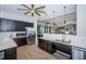 Kitchen space with dark cabinets, stainless steel appliances, and modern lighting at 6482 Beverly Hills Dr, Zephyrhills, FL 33541