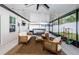 Enclosed lanai featuring a hot tub, comfortable seating, and string lights for a relaxing atmosphere at 6482 Beverly Hills Dr, Zephyrhills, FL 33541