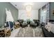 Cozy sitting room showcasing stylish decor, including a chandelier, comfortable chairs, and accent wall at 6482 Beverly Hills Dr, Zephyrhills, FL 33541