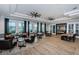 Spacious lounge with hardwood floors, comfortable seating, and modern lighting at 6482 Beverly Hills Dr, Zephyrhills, FL 33541