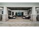 Spacious patio with elegant stone columns, ample seating, and stylish black ceiling fans for outdoor relaxation at 6482 Beverly Hills Dr, Zephyrhills, FL 33541