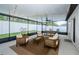Enclosed patio featuring outdoor seating, dining set, and string lights at 6482 Beverly Hills Dr, Zephyrhills, FL 33541