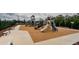 Well-maintained playground with multiple slides and play structures surrounded by wood mulch and benches, ideal for recreation at 6482 Beverly Hills Dr, Zephyrhills, FL 33541