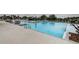 Beautiful pool with a spacious deck, lounge chairs, and well-maintained landscaping providing a luxurious and relaxing environment at 6482 Beverly Hills Dr, Zephyrhills, FL 33541