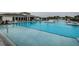 Large community pool with multiple sections, lounge chairs, and a spacious deck, offering a resort-style experience at 6482 Beverly Hills Dr, Zephyrhills, FL 33541