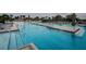 Inviting community pool featuring shallow water entry, lounge areas, and surrounding greenery for a serene and enjoyable experience at 6482 Beverly Hills Dr, Zephyrhills, FL 33541