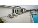 Relaxing pool deck featuring comfortable lounge chairs, manicured landscaping, and a clear view of the sparkling community pool at 6482 Beverly Hills Dr, Zephyrhills, FL 33541